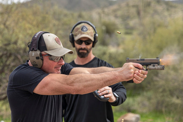 shooting-instructor-student-firing-glock-surefire-x300